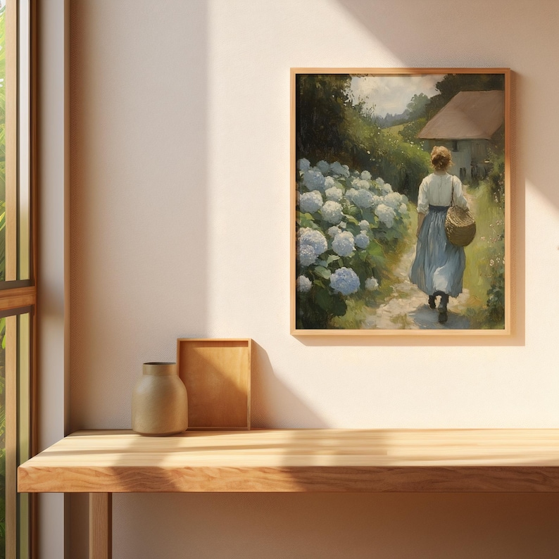 May include: A painting of a woman walking through a garden path lined with white hydrangeas. The woman is wearing a blue dress and carrying a basket. A small house is visible in the background.