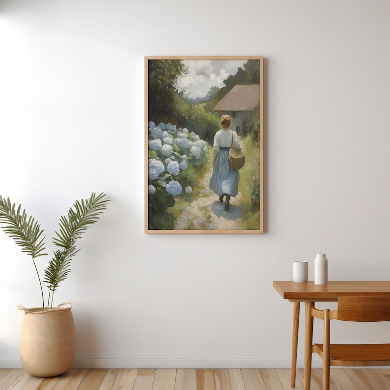 May include: A painting of a woman walking down a path lined with white hydrangeas. The woman is wearing a blue dress and carrying a basket. A small house is visible in the background.