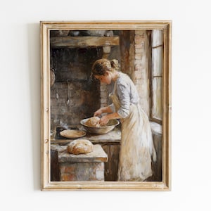 May include: A framed painting shows a woman in a kitchen, kneading dough. She wears a light blue shirt and a white apron. A loaf of bread sits on a brick surface. The scene is set in a rustic kitchen with a brick wall and a window.