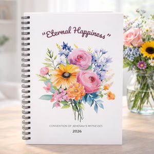 May include: A white spiral-bound notebook with the text "Eternal Happiness" and a floral bouquet illustration. The bouquet features pink roses, yellow sunflowers, and blue and orange flowers. The text "Convention of Jehovah's Witnesses 2026" is also visible.