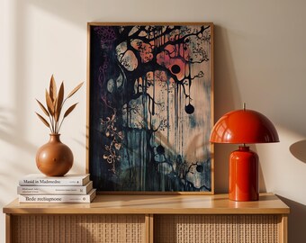 May include: A framed abstract art print with a dark blue background and a colorful tree with dripping paint. The print is hanging on a wall above a wooden shelf with books and a red lamp.
