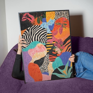 May include: Abstract art print featuring a colorful collage of geometric shapes, animal prints, and floral patterns. The print is framed in black and has a modern, eclectic style.
