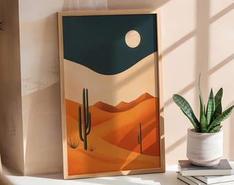 May include: A framed print of a desert landscape with a full moon in the sky. The print features a dark blue sky, orange sand dunes, and two tall cacti. The frame is made of wood and has a natural finish.