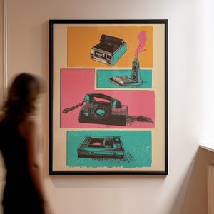 May include: A framed poster with a retro design featuring a vintage camera, a rotary phone, a cassette player, and a video cassette recorder. The poster is set against a background of pink, yellow, and blue.