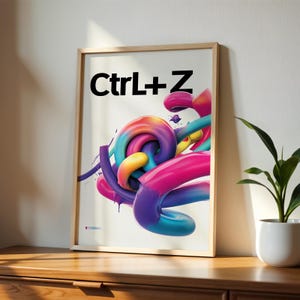 Puede incluir: Impresión artística enmarcada con el texto "Ctrl+Z" en negro. La obra de arte presenta un diseño abstracto vibrante con formas coloridas entrelazadas en tonos de rosa, morado, amarillo y azul. La impresión se muestra en un marco de madera clara.