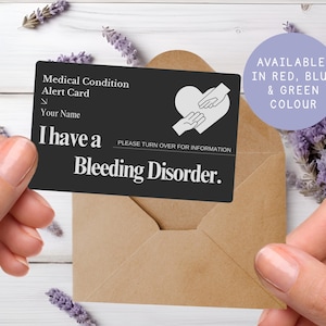 May include: A black medical alert card with white text and a heart symbol with hands. The card reads "I have a Bleeding Disorder." A purple circle states "Available in Red, Blue & Green Colour."