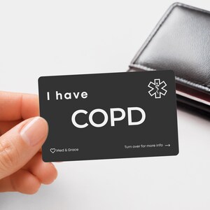 May include: A rectangular black medical alert card with white text that reads I have COPD. The card features a white Star of Life medical symbol in the top right corner, a small heart icon with the text Med & Grace, and Turn over for more info.