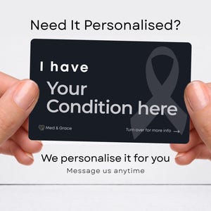 May include: A rectangular black medical alert card featuring the white text I have Your Condition here, a grey awareness ribbon graphic, the Med & Grace logo, and the instruction Turn over for more info with an arrow pointing to the right.