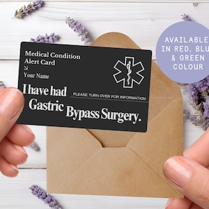 May include: A black medical alert card with white text, held in front of a brown envelope. The card reads "Medical Condition Alert Card" and "I have had Gastric Bypass Surgery." A purple circle states "Available in Red, Blue & Green Colour."