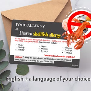 May include: A red and white food allergy card with a red circle and a diagonal line through it. The circle contains a lobster and a few mussels. The card reads "I have a shellfish allergy." and lists various types of shellfish, including crab, shrimp, lobster, squid, mussels, oysters, prawns, scallops, and octopus. The card also includes the text "Does this food contain shellfish?" and "Caution! To keep me safe, please use clean gloves, utensils, frying oil and surfaces when making my food. Thank you!"