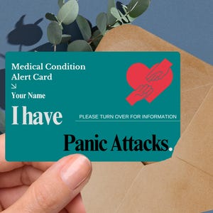 May include: A teal medical alert card with a red heart and two hands holding it. The card says "Medical Condition Alert Card" and "I have Panic Attacks."