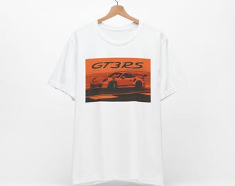 May include: White t-shirt with an orange graphic of a Porsche GT3RS race car on a track.