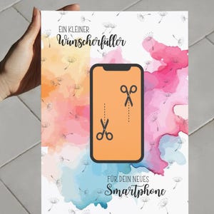 May include: A rectangular card featuring a watercolor background in shades of yellow, pink, and blue with dandelion seed illustrations. The center displays a smartphone icon with scissors and a dashed cut line. Text reads: EIN KLEINER Wunscherf&uuml;ller F&Uuml;R DEIN NEUES Smartphone.