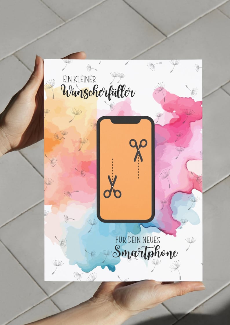 May include: A rectangular card featuring a watercolor background in shades of yellow, pink, and blue with dandelion seed illustrations. The center displays a smartphone icon with scissors and a dashed cut line. Text reads: EIN KLEINER Wunscherf&uuml;ller F&Uuml;R DEIN NEUES Smartphone.