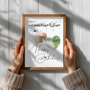 K&ouml;nnte beinhalten: Ein gerahmter Druck mit dem Text "kleiner Wunscherf&uuml;ller" und "Happy Birthday" in schwarzer Schrift. Es sind zwei herzf&ouml;rmige Luftballons abgebildet, wobei einer einen F&uuml;nf-Euro-Schein und der andere einen Hundert-Euro-Schein enth&auml;lt.