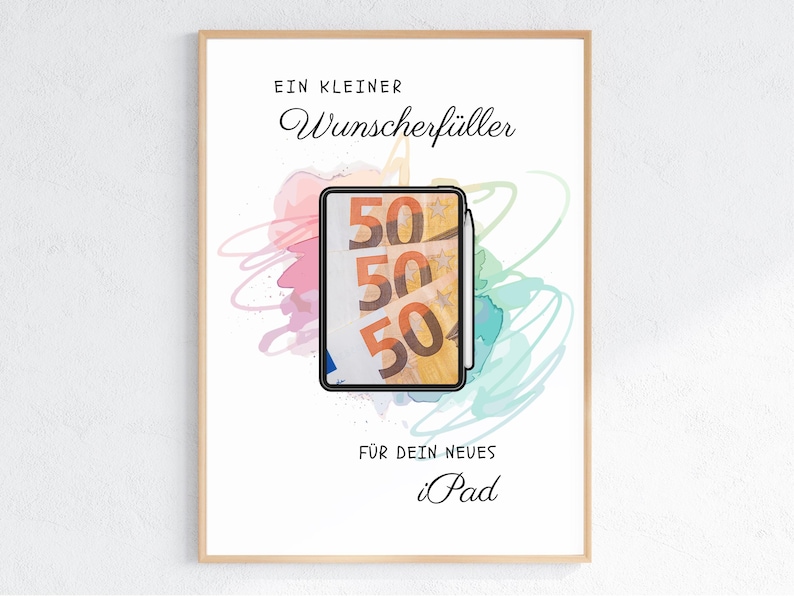 May include: A framed print featuring a tablet displaying a fifty euro banknote graphic. The background has colorful watercolor scribbles. Text reads: EIN KLEINER Wunscherf&uuml;ller F&Uuml;R DEIN NEUES iPad. The design is centered within a light wood frame.