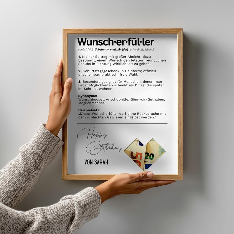 May include: A framed print with the German word "Wunscherf&uuml;ller" at the top, meaning "wish fulfiller". The print includes definitions, synonyms, and a sample sentence. The words "Happy Birthday" and "Von Sarah" are also visible.