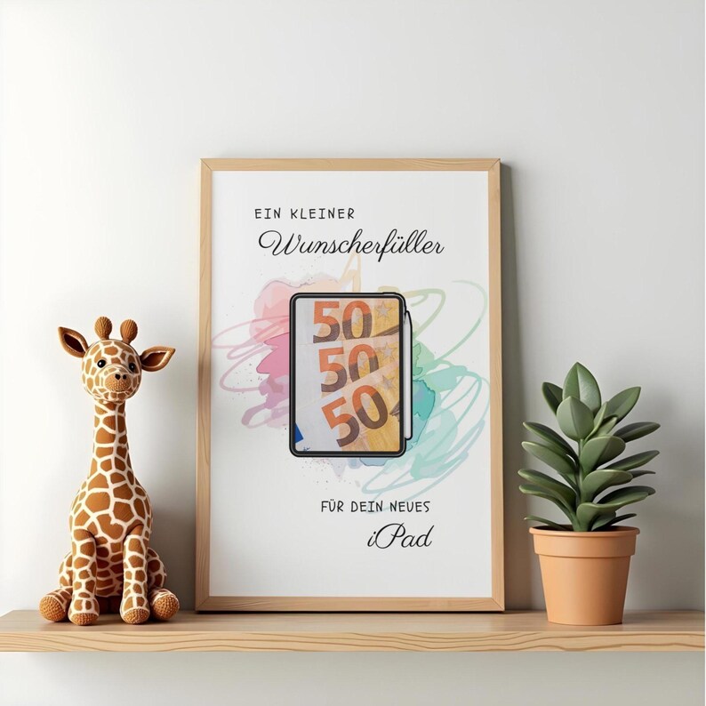 May include: A framed print featuring the German text "EIN KLEINER Wunscherf&uuml;ller F&Uuml;R DEIN NEUES iPad" with a central illustration of a tablet displaying three fifty-euro banknotes against a background of colorful, abstract watercolor-style brush strokes.