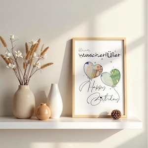K&ouml;nnte beinhalten: Ein gerahmter Druck mit dem Text "kleiner Wunscherf&uuml;ller" und "Happy Birthday" in schwarzer Schreibschrift. Das Design zeigt zwei herzf&ouml;rmige Luftballons, einer gef&uuml;llt mit einem 50-Euro-Schein und der andere mit einem 10-Euro-Schein, auf wei&szlig;em Grund.