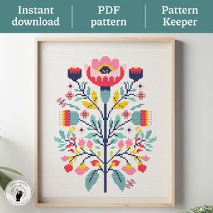 May include: Framed cross-stitch pattern featuring a stylized floral design in pink, red, yellow, blue, and green. The artwork is displayed in a light wood frame. Text at the top reads "Instant download", "PDF pattern", and "Pattern Keeper". A circular logo is in the lower left corner.