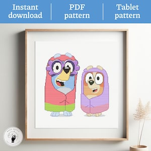May include: Cross-stitch PDF pattern showing two cartoon characters in blankets. The characters are in shades of blue, orange, pink, and purple. The words "Instant download", "PDF pattern", and "Tablet pattern" are at the top. The image is framed.