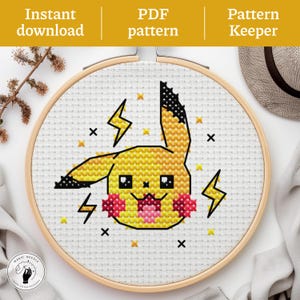 May include: Cross-stitch pattern of Pikachu in a wooden embroidery hoop. The design features a yellow Pikachu face with black accents, pink cheeks, and lightning bolts. The text "Instant download", "PDF pattern", and "Pattern Keeper" are at the top.