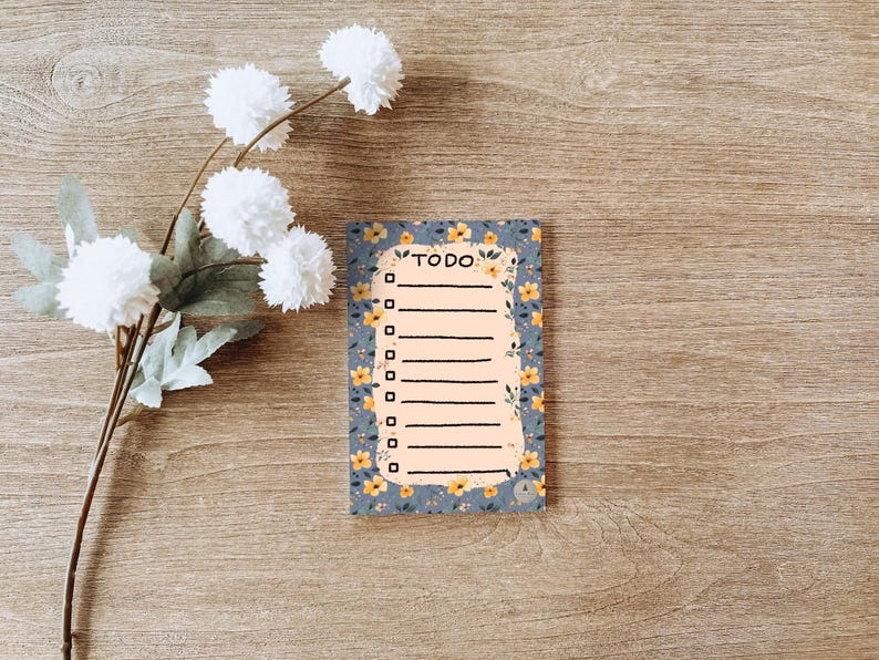 May include: A blue and white floral patterned notepad with a checklist and the word "TODO" at the top.
