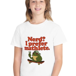 May include: White t-shirt with the text "Nerd? I prefer mathlete." in orange letters. A cartoon frog wearing a green hat and sunglasses is on a skateboard. The frog is giving a peace sign.
