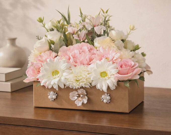 Artificial flowers, spring has sprung, pinks, whites, creams, and a brown box with bling.