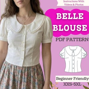 以下が含まれることがあります： 黒い持ち手と「But First, Coffee」の文字が黒い手書き風フォントで書かれた白いセラミックマグ。マグカップは白い表面に置かれています。