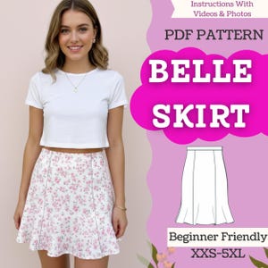 May include: A woman wearing a white crop top and a floral print skirt. The skirt has a pink floral pattern on a white background. The image includes text that reads "BELLE SKIRT" and "PDF PATTERN". The pattern is beginner friendly and available in sizes XXS-5XL.