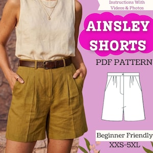 Può includere: Una modella indossa pantaloncini verde oliva con una cintura marrone e un top color crema. L'immagine include il testo "Ainsley Shorts PDF Pattern" e "Beginner Friendly XXS-5XL".