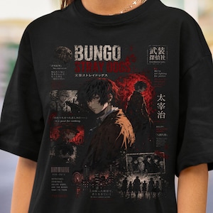 May include: A black t-shirt featuring a graphic print from Bungo Stray Dogs. The design includes the title text, Japanese characters, and multiple illustrations of characters in a dark, red-accented style with city silhouettes and text.