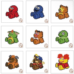 May include: A collection of nine pixel art cross-stitch patterns featuring various colorful characters. Each square design displays a seated figure, including a red monster, blue monster, brown bear, green creature, and others, with a small circular logo.