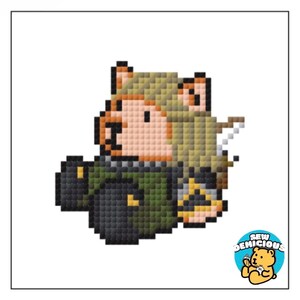 May include: Pixelated illustration of a character in a green and black outfit, holding a bow and arrow and a container. The character has blonde hair and a light skin tone. The image includes the text "SEW DENICIOUS" and a bear logo.