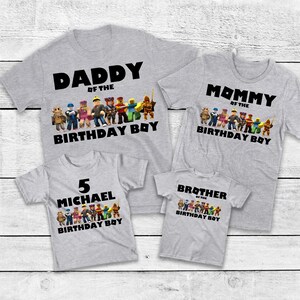 May include: Four gray t-shirts with black text and colorful graphics. The shirts read "Daddy of the Birthday Boy", "Mommy of the Birthday Boy", "5 Michael Birthday Boy", and "Brother of the Birthday Boy".