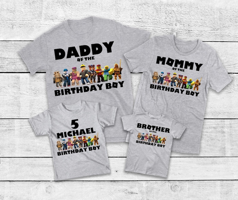 May include: Four gray t-shirts with black text and colorful graphics. The shirts read "Daddy of the Birthday Boy", "Mommy of the Birthday Boy", "5 Michael Birthday Boy", and "Brother of the Birthday Boy".