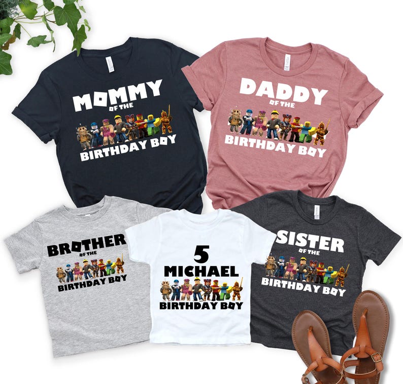 May include: Five short-sleeved t-shirts in various colors, including navy, pink, gray, white, and charcoal. Each shirt features a graphic of characters and the words "Mommy," "Daddy," "Brother," "Sister," or a name, with "Birthday Boy" below.