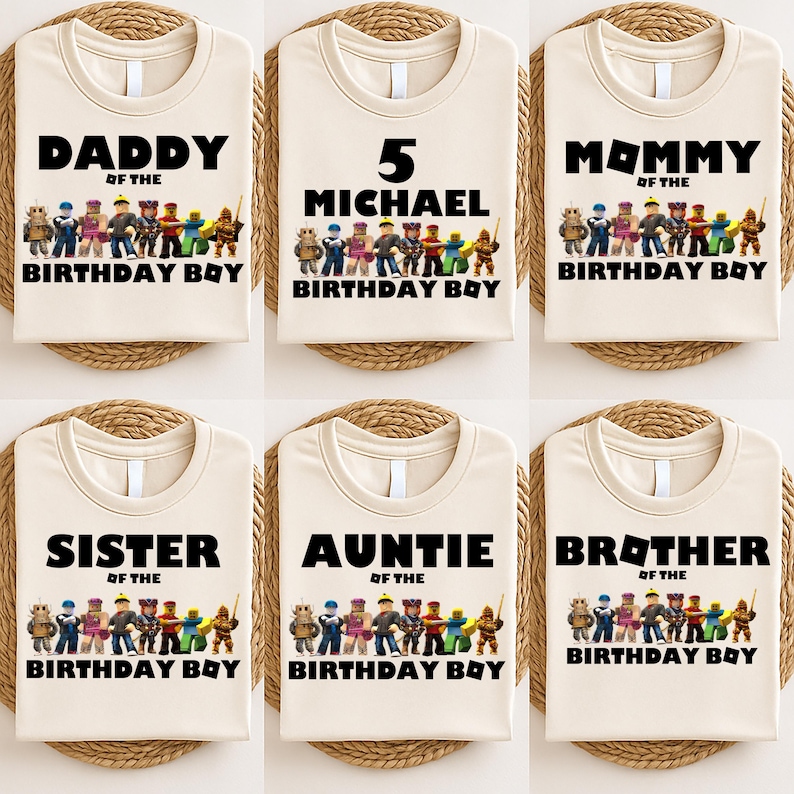 May include: Six beige t-shirts with black text and a colorful graphic of toy figures. The shirts read "DADDY", "5 MICHAEL", "MOMMY", "SISTER", "AUNTIE", and "BROTHER" above "BIRTHDAY BOY".