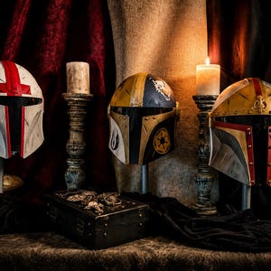 May include: Four Mandalorian helmets in various colors, including white with red accents, gold and black, and gold with red trim, are displayed on stands. A lit candle sits next to each helmet. A small treasure chest is in the foreground.