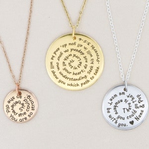 May include: Three silver necklaces with round pendants. The pendants have inspirational quotes engraved on them. The quotes are: "You are so precious she believed she could", "I know am I mom you be there for you", and "Seek his will in all you do, and he will show you which path to take. -Proverbs 9:10".