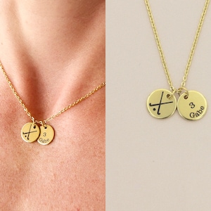 collage of model wearing necklace and closeup of gold necklace with two discs showing field hockey symbol and number name of player on cream background