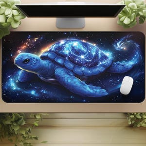 May include: A rectangular mousepad featuring a blue sea turtle design with a starry galaxy pattern on its shell. The mousepad has a black background with a white computer mouse on the right side. The turtle is a vibrant blue color.