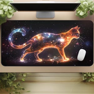 May include: A black rectangular mouse pad featuring a stylized cat silhouette filled with a galaxy design in orange, blue, and white. A white computer mouse is on the right side of the pad.