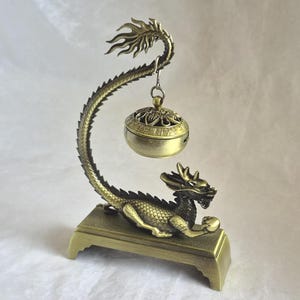 Unusual vintage style metal incense burner, bell hangs from tail of dragon - 13.5cm tall