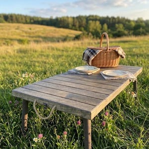 May include: A white ceramic mug with a black handle and the text "But First, Coffee" in a black, bold font. The mug is sitting on a wooden surface. The mug is approximately 4 inches tall.
