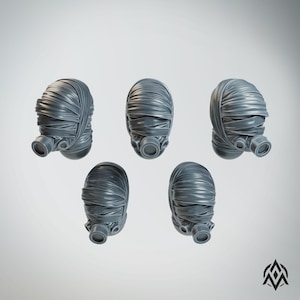May include: Five gray, wrapped head sculptures with attached respirator-style masks. The heads are oval-shaped and wrapped in textured bands, with the masks featuring circular openings. The objects are set against a plain, light background.