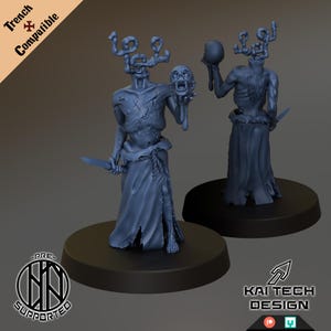 May include: Two dark blue fantasy miniatures of humanoid figures, each with a unique headpiece and holding a skull or knife. One figure holds a severed head. The figures stand on black circular bases. The image includes text that says "Trench Compatible" and "Kai Tech Design".