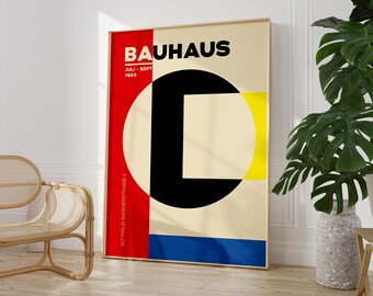 May include: A Bauhaus poster featuring a geometric design in red, black, yellow and blue. The poster includes the text "Bauhaus" and "Juli - Sept 1923".