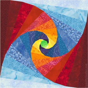 Puede incluir: Una colcha colorida con un diseño en espiral en tonos de rojo, naranja, amarillo, azul y verde. El centro de la espiral es un pequeño cuadrado verde.